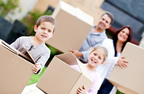 Local removals team handling furniture in a Bickley property